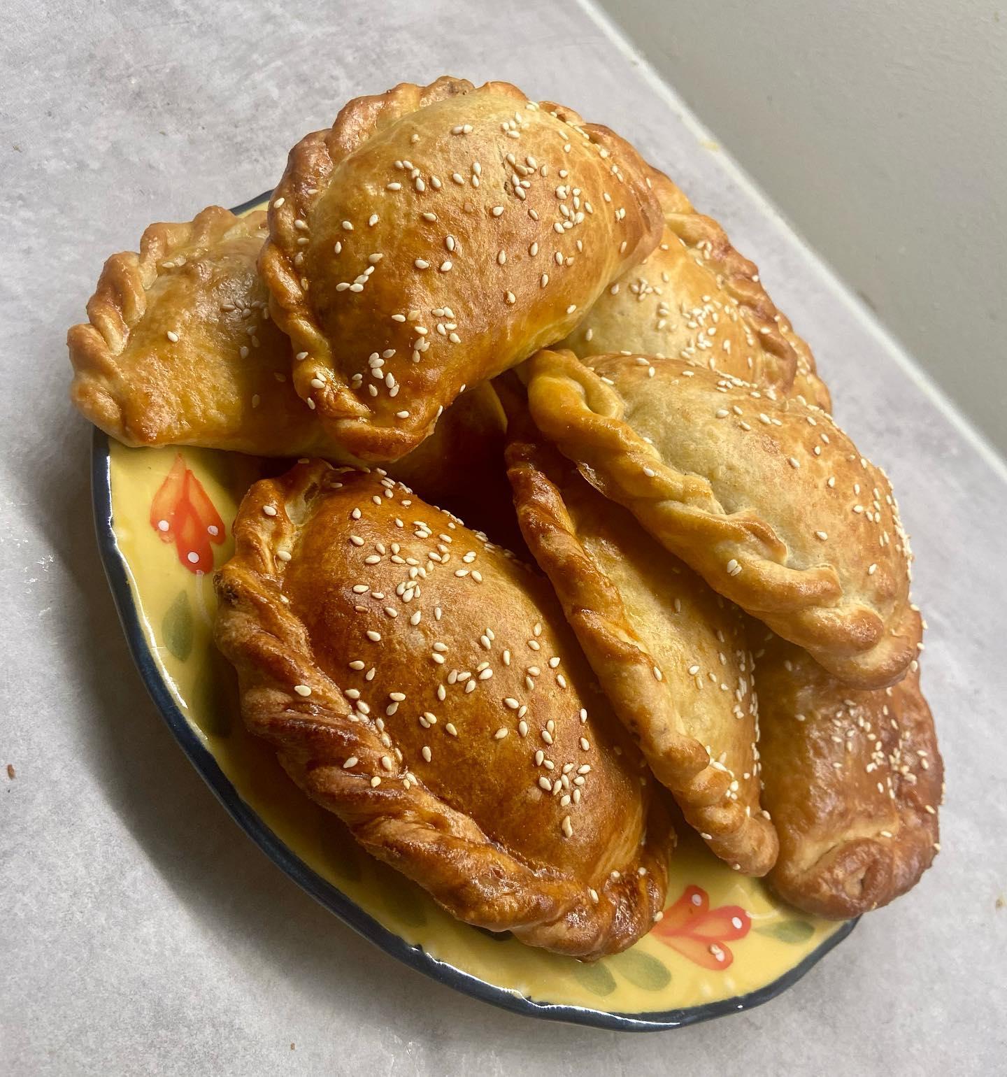 Freshly baked Peruvian empanadas on a plate